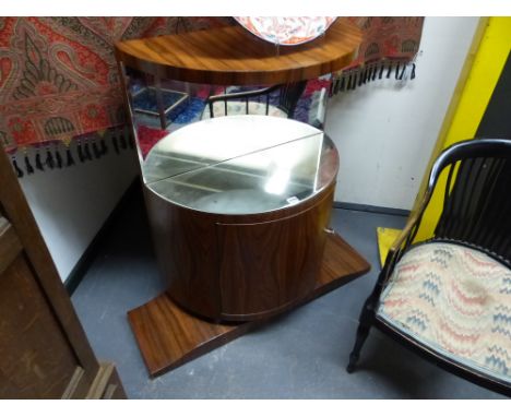 AN UNUSUAL ROSEWOOD BOW FRONT MIRROR BACK ART DECO STYLE  CABINET WITH SHAPED PLATFORM BASE.   H.106, W.106, D.36cms.