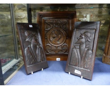 THREE ANTIQUE CARVED OAK PORTRAIT PANELS, A PAIR WITH PROFILES AND A LARGER EXAMPLE WITH CENTRAL ROUNDEL.    SIZE OF LARGEST 