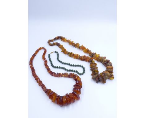 A STRING OF NATURAL UNPOLISHED GRADUATED AMBER (APPROX 78cms 30.5") TOGETHER WITH A FURTHER STRING OF AMBER COLOURED IRREGULA