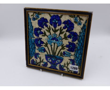 A FRAMED EASTERN GLAZED TILE WITH FLORAL BOUQUET DESIGN.   21x21cms.