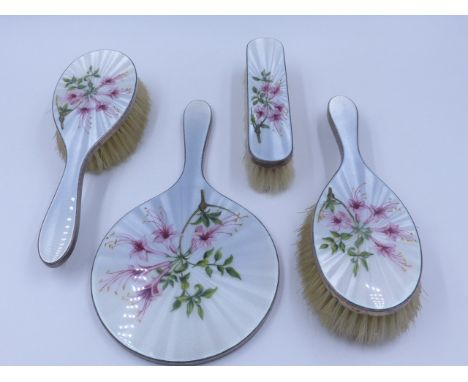 A HALLMARKED SILVER FIVE PIECE DRESSING TABLE SET DATED LONDON 1962 WITH A GUILLOCHE ENAMEL FLORAL DESIGN ON REVERSE. 