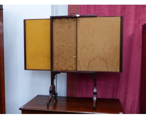 A REGENCY MAHOGANY ADJUSTABLE FIRESCREEN WITH SABRE LEGS ENDING IN BRASS CAP CASTORS TOGETHER WITH A LATER CARVED EDWARDIAN S
