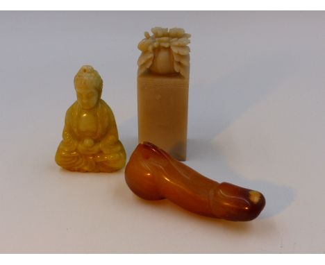 THREE CHINESE CARVED HARDSTONE ARTICLES, A SEATED DEITY, A SEAL AND AN ARCHAIC RITUAL OBJECT.