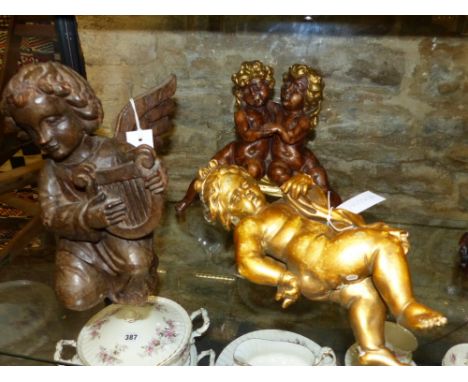 THREE ANTIQUE AND LATER FIGURES OF CHERUBS AND CUPIDS,  ONE PLAYING A LYRE.   H.29cms.  (3)
