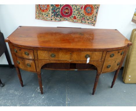 A REGENCY INLAID MAHOGANY BOW FRONT SIDEBOARD WITH CENTRE DRAWER ABOVE TAMBOUR DOORS FLANKED BY DEEP AND SHALLOW DRAWERS ON R