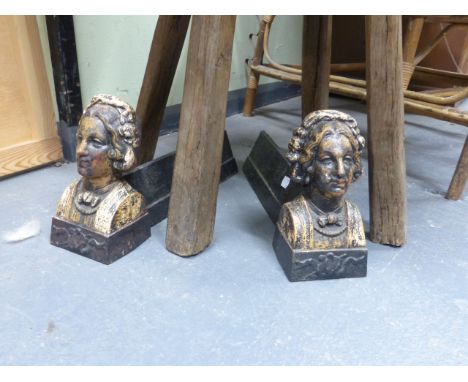 A PAIR OF UNUSUAL CAST IRON FIGURAL ANDIIRONS, EACH DECORATED WITH A PORTRAIT BUST.