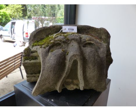 AN EARLY CARVED STONE ARCHITECTURAL ELEMENT OF A GROTESQUE MASK.   H.28, W.46cms.