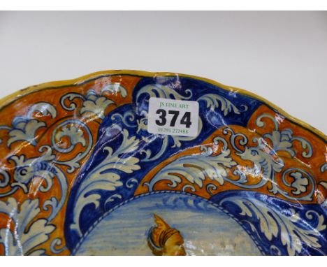 AN ITALIAN MAJOLICA TAZZA WITH WHORL DECORATION AND CENTRE PORTRAIT.   DIA. 23cms x H.5cms  TOGETHER WITH A FAIENCE PLATE DEC