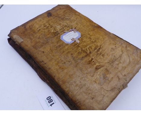 AN INTERESTING EARLY VELLUM BOUND MANUSCRIPT, APPARENTLY IN LATIN AND DATING TO THE LATE 16th.C.