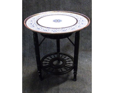 AN EBONISED AESTHETIC STAND WITH ASSOCIATED ROYAL WORCESTER BLUE AND WHITE CIRCULAR TOP.   D.62cms.
