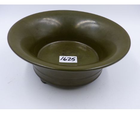 A CHINESE TEA DUST GLAZE FLARED FORM BOWL WITH IMPRESSED SEAL MARKS TO BASE, RAISED ON TRIFID FEET.   D.19.5cms.