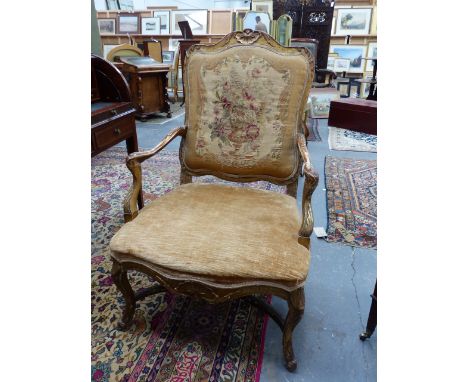 A FRENCH CARVED GILTWOOD ANTIQUE LOUIS XV STYLE ARMCHAIR WITH FLORAL TAPESTRY BACK PANEL.