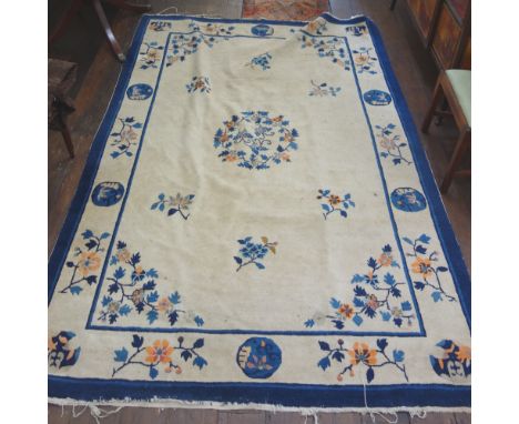 A Chinese carpet, the mushroom field with flowering branches within blue borders, 207cm x 108cm. 