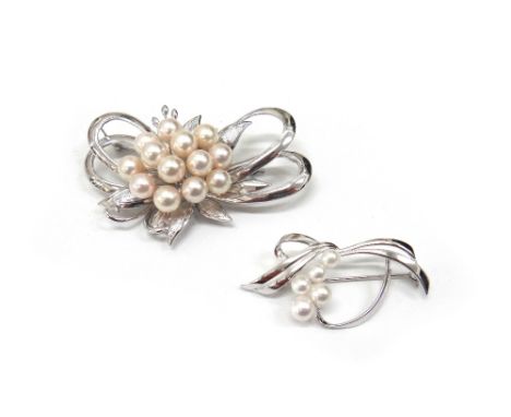A silver and cultured pearl brooch, in a single flowerhead and stylised open box shaped design and a smaller cultured pearl s
