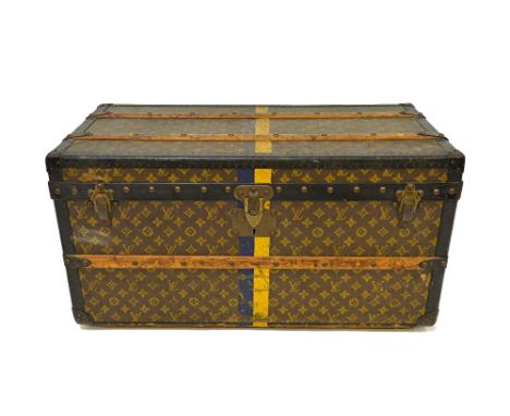 A Louis Vuitton monogram trunk, no.182684, metal bound and with wooden battens, side carrying handles, two lift out divided i