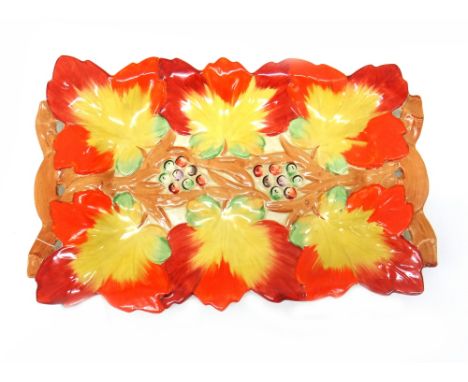 A Clarice Cliff large shaped rectangular dish, moulded and painted with leaves and berries, 39.5cm wide. 