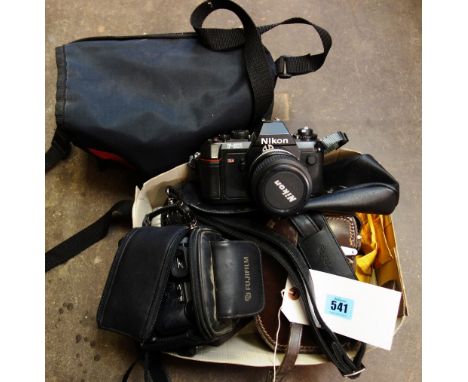 A Bell & Howell sundial cine camera in a leather case, a Nikon F-301 camera with additional lens, a Fujifilm S5500 camera, an