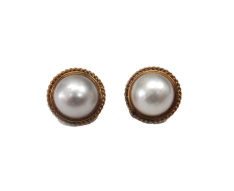 A pair of gold mounted mabé pearl earstuds, each mounted with a large mabé pearl, having a ropetwist wirework surround, the b
