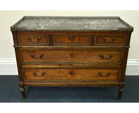 A Directoire mahogany brass mounted commode, the grey fossil marble top with a pierced gallery above three long drawers disgu