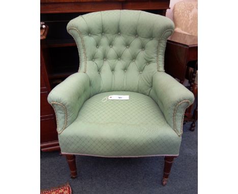 A Regency style armchair, second half 19th century, button down upholstered in green, on ring turned legs and castors. 