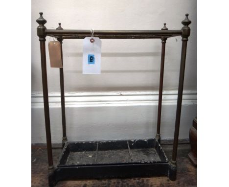A late Victorian brass twelve division stick stand, with cast iron base, 50cm wide. 