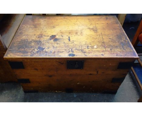 An early 20th century stained pine metal bound trunk, 70.5cm wide, together with a Victorian upholstered nursing chair, (2).