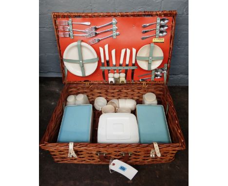 A vintage Sirram wicker picnic hamper, a wicker wine bottle and glass carrier, and a Smith-Corona typewriter, (3).