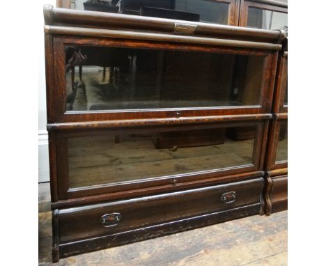 A near pair of Globe Wernicke oak two tier bookcases, with glazed up and over doors, drawers below, 87cm wide and an incomple