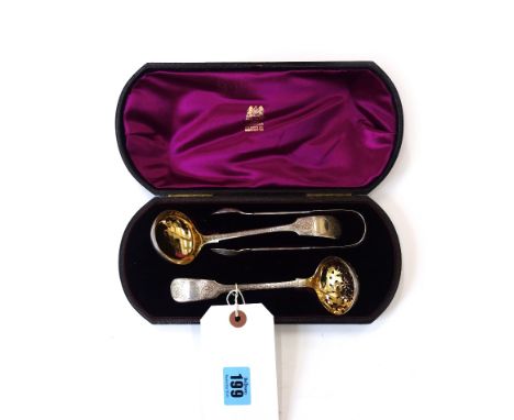 A cased Victorian silver Fiddle pattern sifter spoon and sugar tongs, George W. Adams, London 1878 and a matching cream ladle