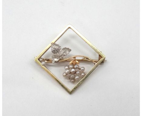 A gold lozenge shaped brooch enclosing a seed pearl fruiting vine, early 20th century, 4.2g gross, 2.2cm wide. 