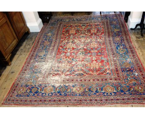 A Tabriz carpet, with red field and blue main border, 309cm x 247cm. 