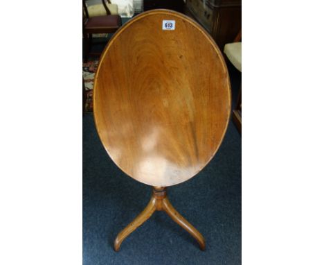 A George III pedestal table, the oval mahogany boxwood banded tilt-top on a baluster turned pillar and tripod base, 66cm wide