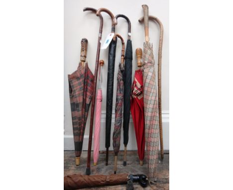 Two gentleman's vintage umbrellas, a walking stick with silver mounts, a rustic walking stick and five various umbrellas, (9)