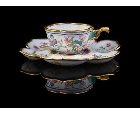 An unusual Chinese enamel cup and saucer, the lobed cup with branch handle and the saucer of petal-form, painted in bright en