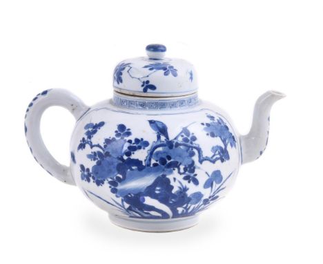 A Chinese blue and white large teapot and cover, Kangxi, the globular body painted with two shaped panels enclosing a bird pe