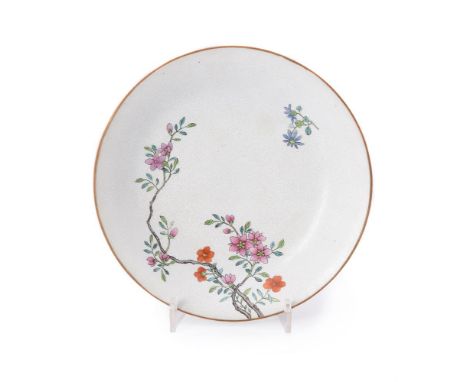 A Chinese Famille Rose small dish, finely painted with flowering branches on an incised white floral ground, the reverse rim 