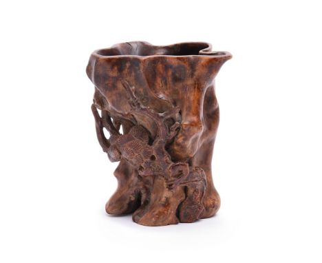 A Chinese boxwood inlaid aloeswood brushpot, Qing Dynasty, of slender irregular form, the organic body formed as a hollowed-o