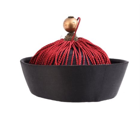 A formal Chinese mandarins hat, late Qing period, circa 1900, with satin brim and red tassels indicating a 9th rank mandarin 