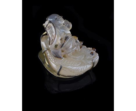 An attractive carved agate carving of a 'boy riding on a fish', Qing Dynasty, the brown natural inclusions skilfully incorpor
