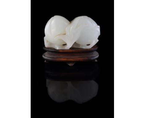 A white jade double 'peach' carving, Qing Dynasty, 18th or 19th century, carved with branches and leaves, the jade 6cm high x
