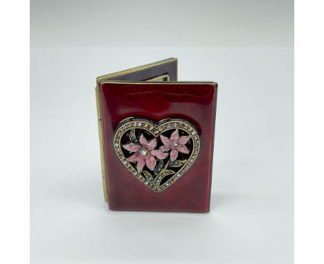 Exquisite folding frame, adorned with opulent red enamel, showcases a crystal-encrusted heart accented by two delicate pink f