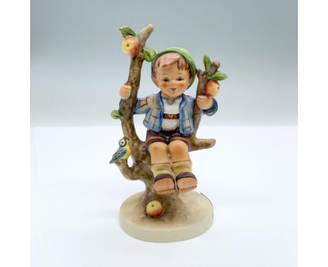 Hand-painted figurine depicting a boy sitting in an apple tree. Goebel backstamp on the bottom. Dimensions: 3"L x 2.5"W x 5.7