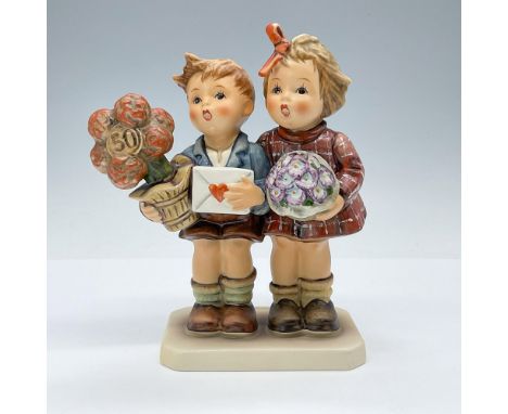 The porcelain figurine was crafted to celebrate the 50th Jubilee of M.I. Hummel and features a commemorative seal on the base