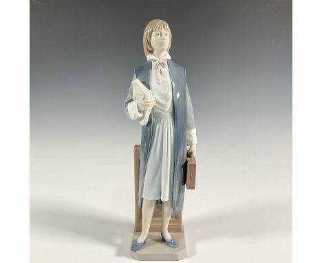 A glossy figure of a young lawyer holding a briefcase and a stack of papers. Lladro backstamp. This item has its original box