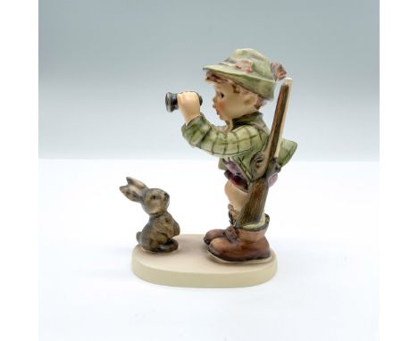 Hand-painted figurine depicting a boy holding binoculars and rifle with a bunny right in front of him. Goebel backstamp on th