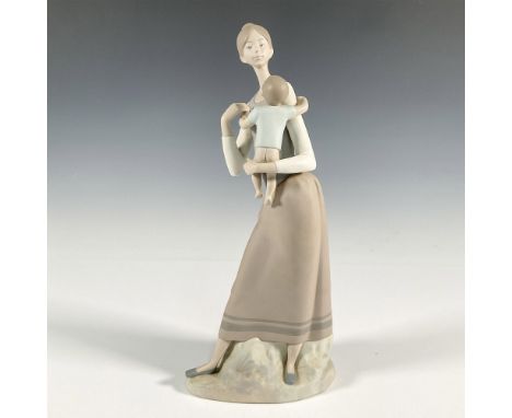 A matte figure of a mother holding her child. Lladro backstamp. This item has its original box: 16"L x 6.5"W x 6.5"H. Artist: