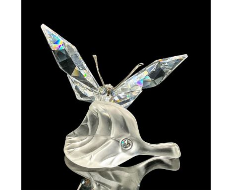 Clear faceted crystal figure of a butterfly resting on a frosted crystal leaf. Swarovski mark. Item number 7615NR000003. Part