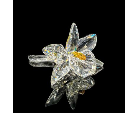 Clear faceted crystal figure of an orchid with a deep yellow pistil. Swarovski mark. Item number 7478NR000002. Part of the Ex