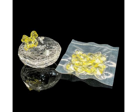 Clear faceted crystal box with lid. A clear yellow bow adorns the lid. Includes small yellow crystal hearts. Swarovski mark. 