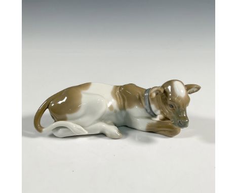 A glossy figure of a brown spotted cow. Lladro backstamp. This item has its original box: 10.25"L x 5"W x 4.5"H. Artist: Juan